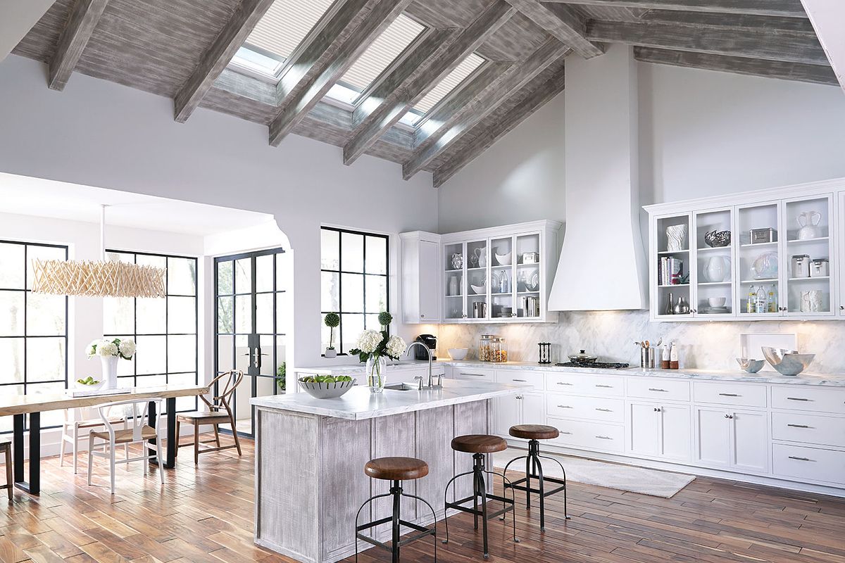 Large open kitchen with VELUX skylights and white shades
